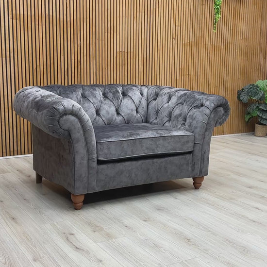 Product tour of the Gosford Charcoal Grey Snuggler Chair, demonstrating the cushion loft, fabric texture, and classic wooden feet.