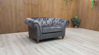 Product tour of the Gosford Charcoal Grey Snuggler Chair, demonstrating the cushion loft, fabric texture, and classic wooden feet.