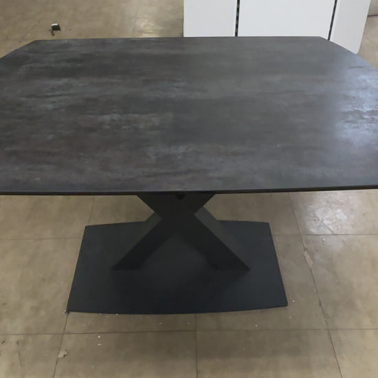 A video of a Modern dining table with a dark wood finish