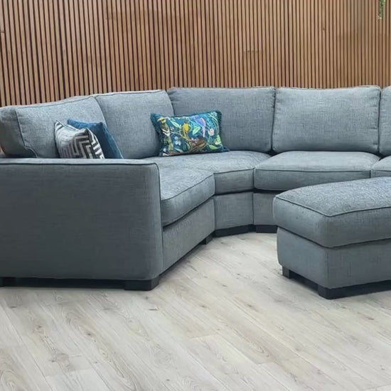 Video Of ‘Elora’ left-hand facing corner sofa with a matching small storage footstool, beautifully tailored in textured Kento 229 Deep Sea Blue fabric.