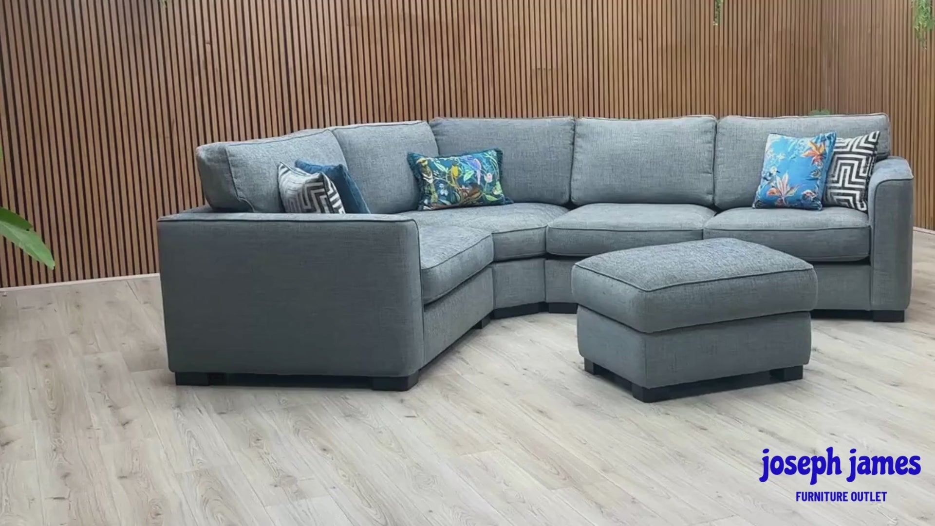 Video Of ‘Elora’ left-hand facing corner sofa with a matching small storage footstool, beautifully tailored in textured Kento 229 Deep Sea Blue fabric.