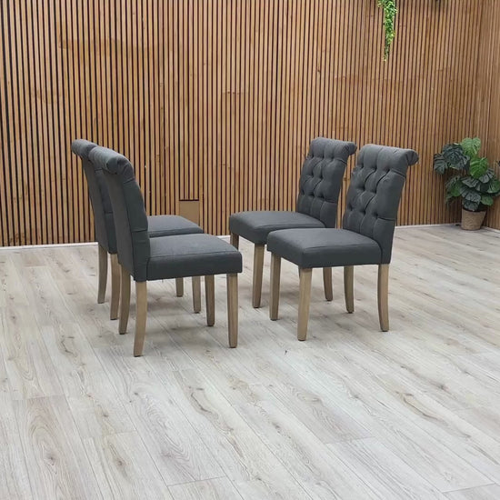 Video Of ‘Lewis’ contemporary dining chairs, showing a matching set of 4 individual chairs beautifully upholstered in a luxurious, durable Anthracite Grey fabric with an elegant button-back design.