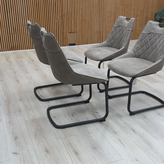 Video walk-around of the taupe Warrior chairs, demonstrating the fabric texture and the flex of the cantilever frame.