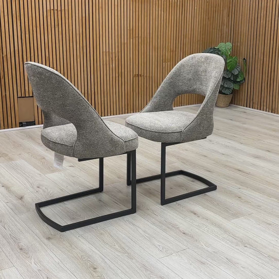 Product video tour of the ‘Tiber’ Truffle Brown Fabric Cantilever Dining Chairs, demonstrating the structural flex and stability of the frame, fabric resilience, and overall build quality.
