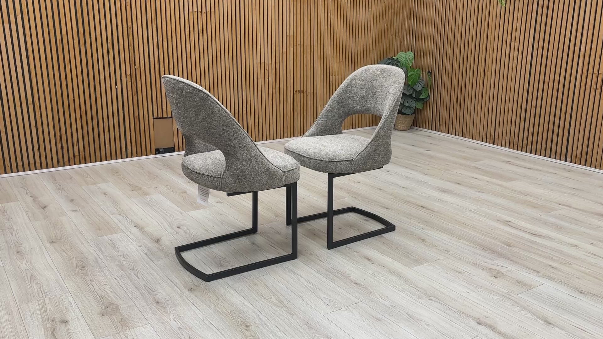 Product video tour of the ‘Tiber’ Truffle Brown Fabric Cantilever Dining Chairs, demonstrating the structural flex and stability of the frame, fabric resilience, and overall build quality.
