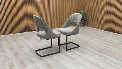 Product video tour of the ‘Tiber’ Truffle Brown Fabric Cantilever Dining Chairs, demonstrating the structural flex and stability of the frame, fabric resilience, and overall build quality.