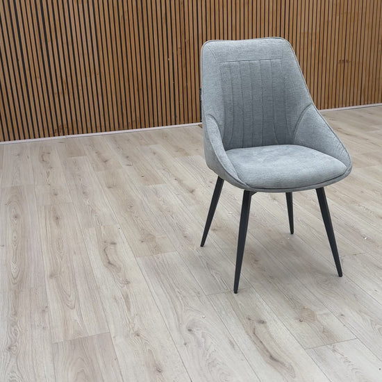 Video Of ‘Crete’ contemporary swivel dining chair, beautifully upholstered in a sophisticated, textured Silver fabric with clean, modern lines.