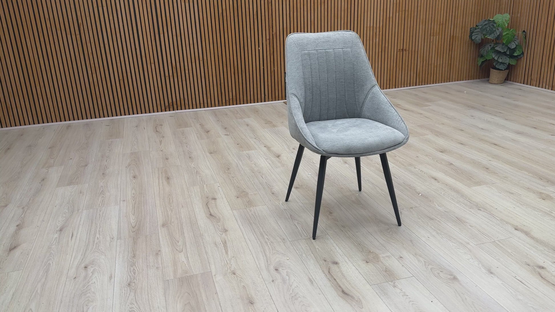 Video Of ‘Crete’ contemporary swivel dining chair, beautifully upholstered in a sophisticated, textured Silver fabric with clean, modern lines.