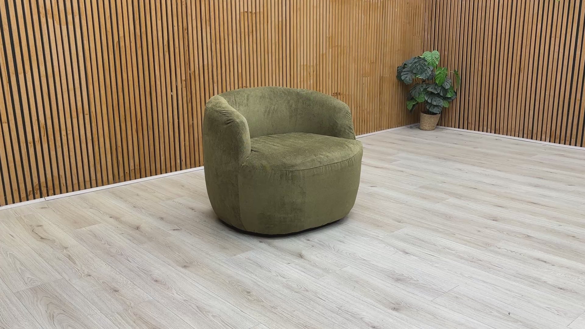 Video tour of the ‘Terry’ swivel chair, showcasing the 360-degree rotation and sage green fabric texture.