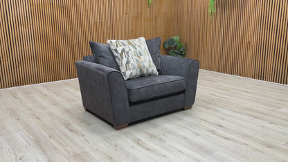 Product walkthrough video demonstrating the Como snuggler chair, showcasing the fabric's soft texture, cushion loft resilience, and its exceptional scale for reading nooks or cozy corners.