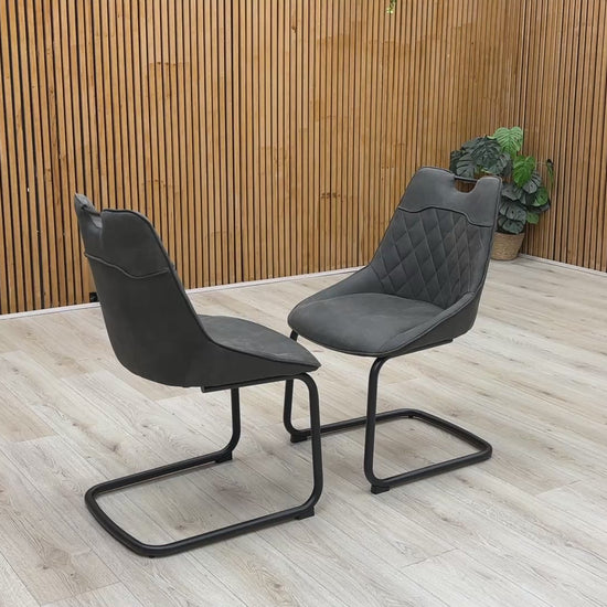Product video tour of the ‘Warrior’ Charcoal Grey Fabric Cantilever Dining Chairs, demonstrating the structural flex and stability of the frame, fabric resilience, and overall build quality.