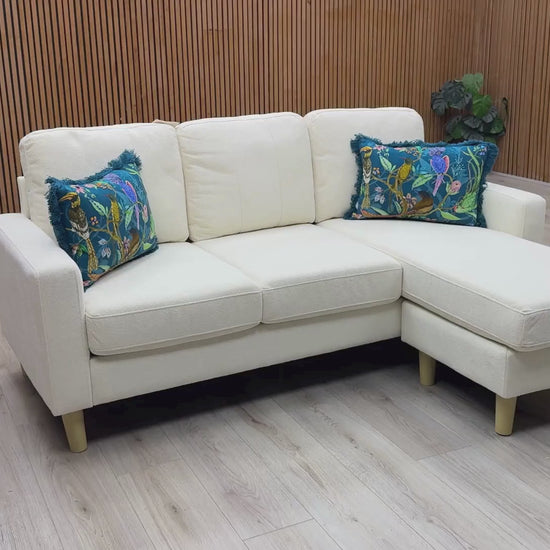Video Of ‘Pad’ compact left-hand facing corner sofa, beautifully tailored in soft, textured natural cream fabric upholstery.