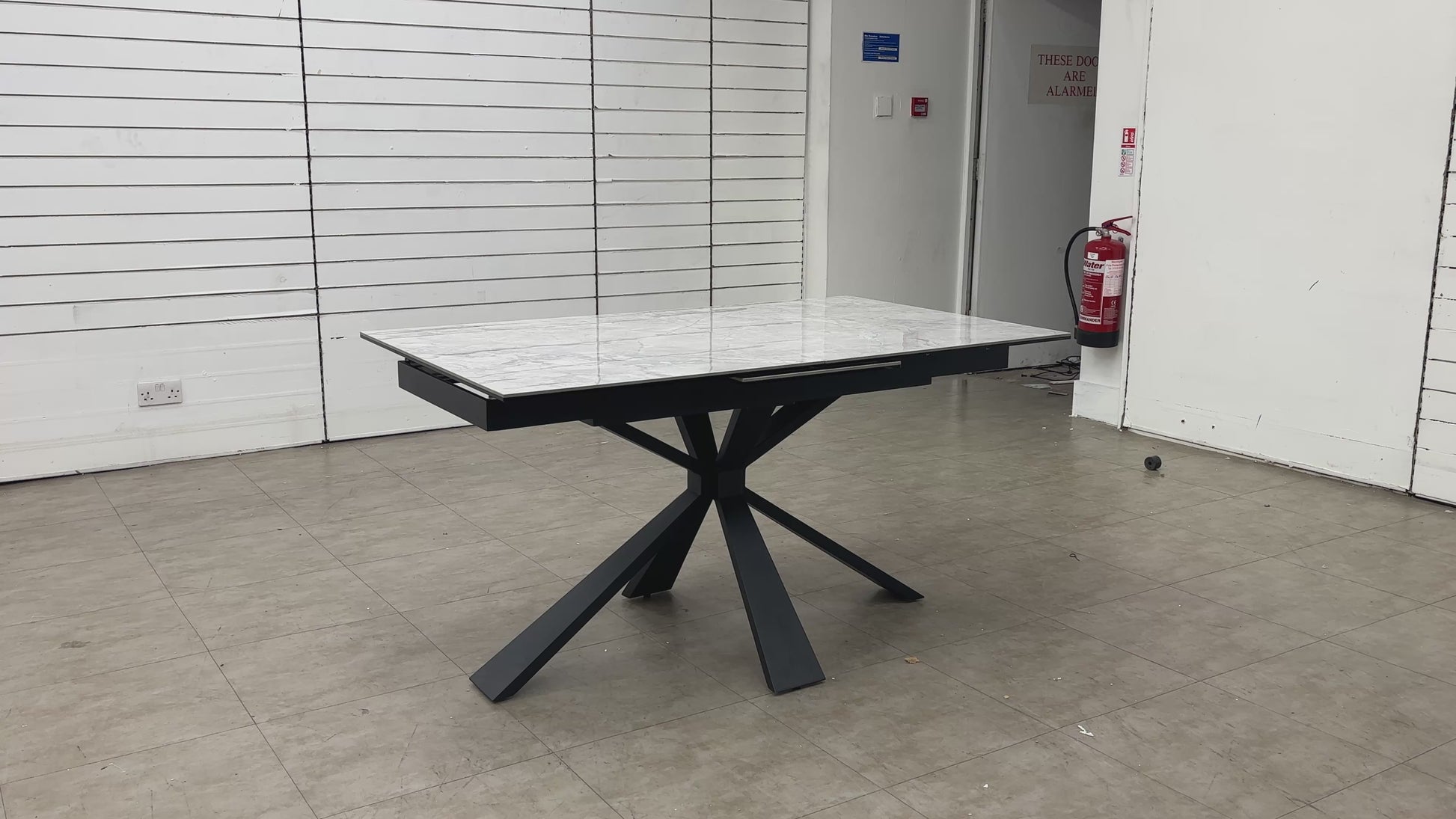 Video Of demonstration of the Crete extending dining table, showcasing the easy-to-use pop-up extension mechanism.