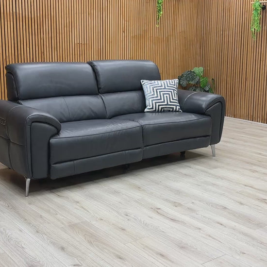 A product demonstration of the Vino Oslo 3 Seater Power Recliner Sofa in Jet Black Leather. The video highlights the smooth, independent movement of the power recliners and headrests, demonstrates the built-in USB charging, and showcases the luxurious heated seat feature designed for ultimate home comfort.