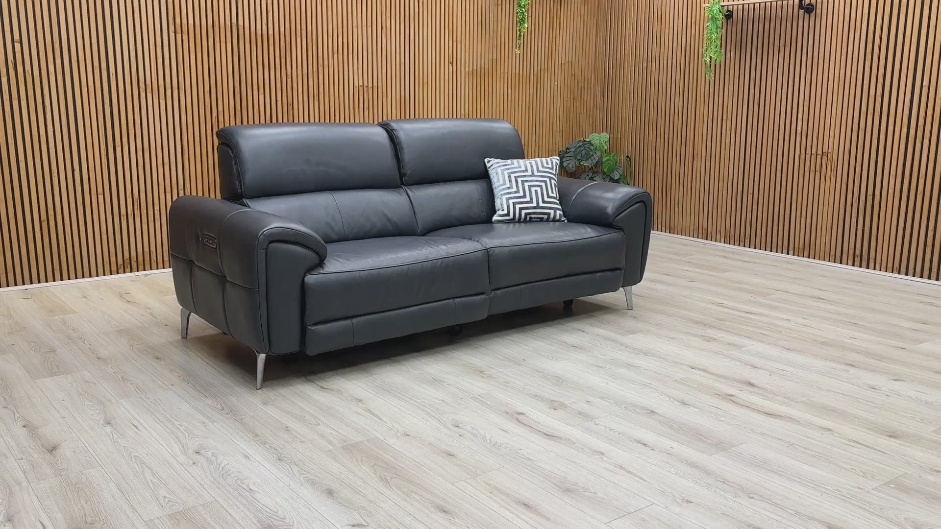 A product demonstration of the Vino Oslo 3 Seater Power Recliner Sofa in Jet Black Leather. The video highlights the smooth, independent movement of the power recliners and headrests, demonstrates the built-in USB charging, and showcases the luxurious heated seat feature designed for ultimate home comfort.