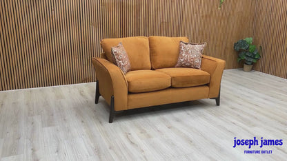 Video Of ‘Collins’ contemporary living room furniture set, featuring a 3-seater sofa and a matching 2-seater sofa, beautifully upholstered in unique Almond Orange towel velvet fabric.
