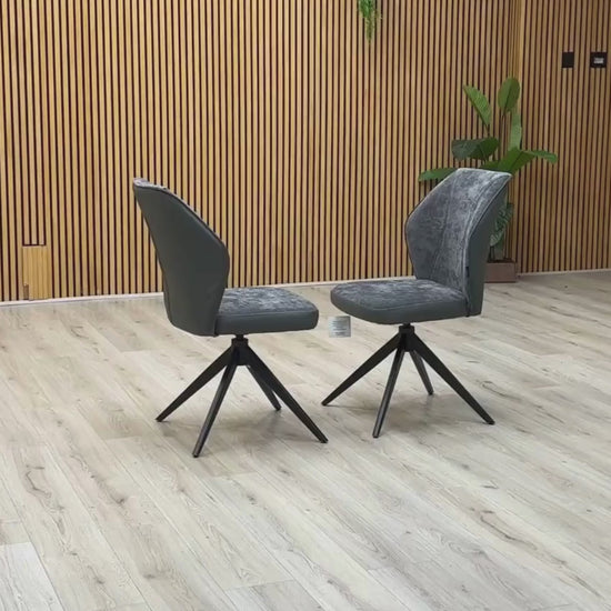 Video Of ‘Julio’ contemporary dining chairs, featuring a matching set of 2 elegantly sculpted seats upholstered in high-grade Anthracite Grey fabric with a sleek black metal base frame.