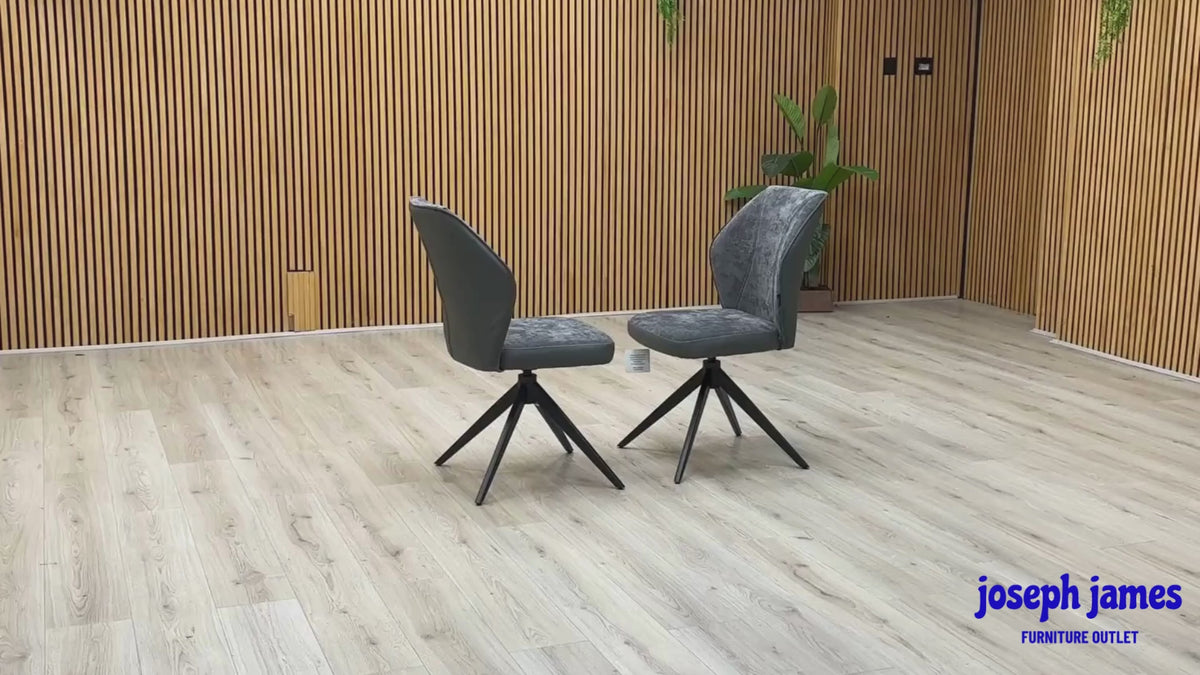 Video Of ‘Julio’ contemporary dining chairs, featuring a matching set of 2 elegantly sculpted seats upholstered in high-grade Anthracite Grey fabric with a sleek black metal base frame.