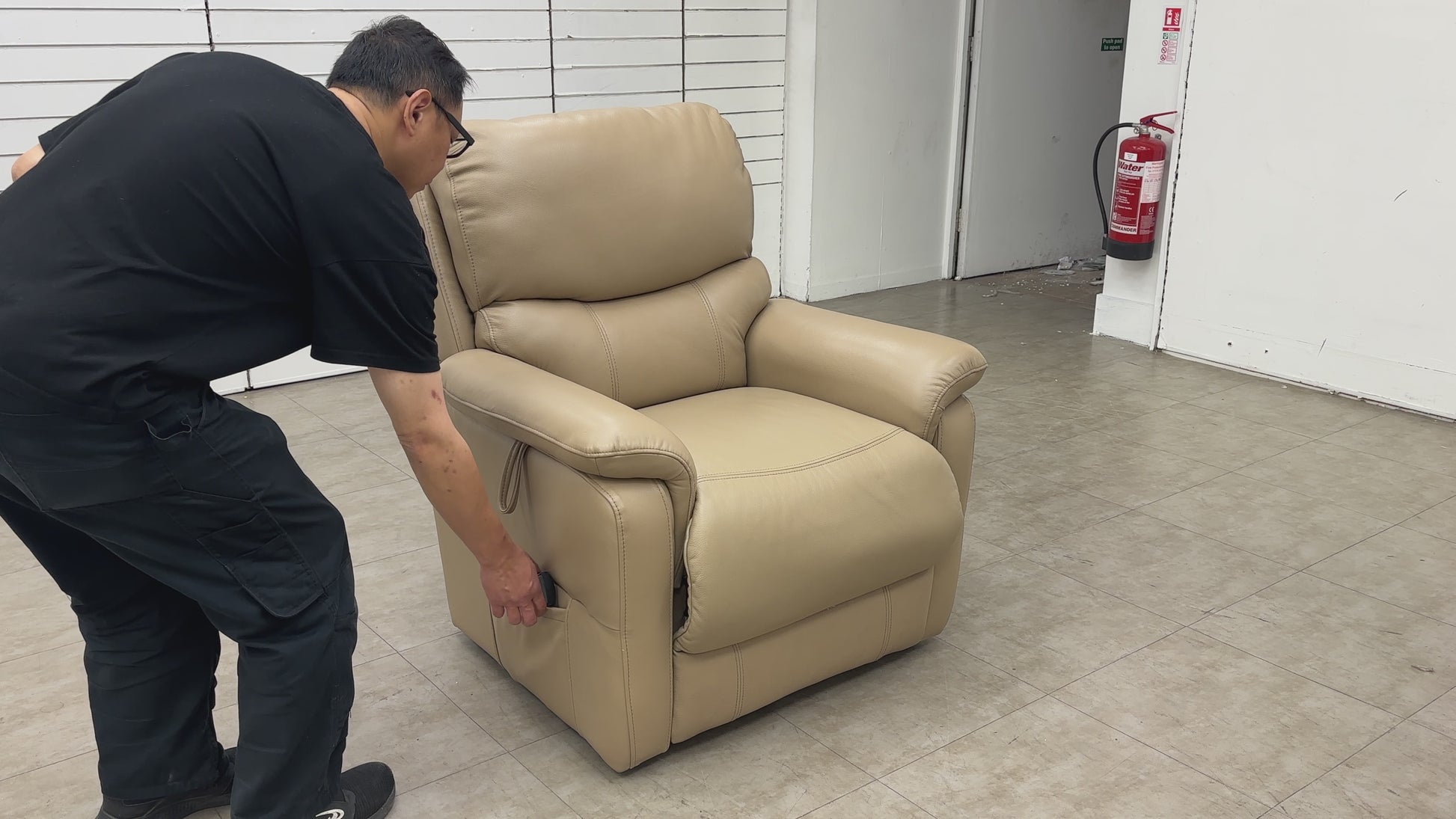 The 'Evelyn' chair in the fully raised and tilted "lift and rise" position, assisting the user in standing up safely.