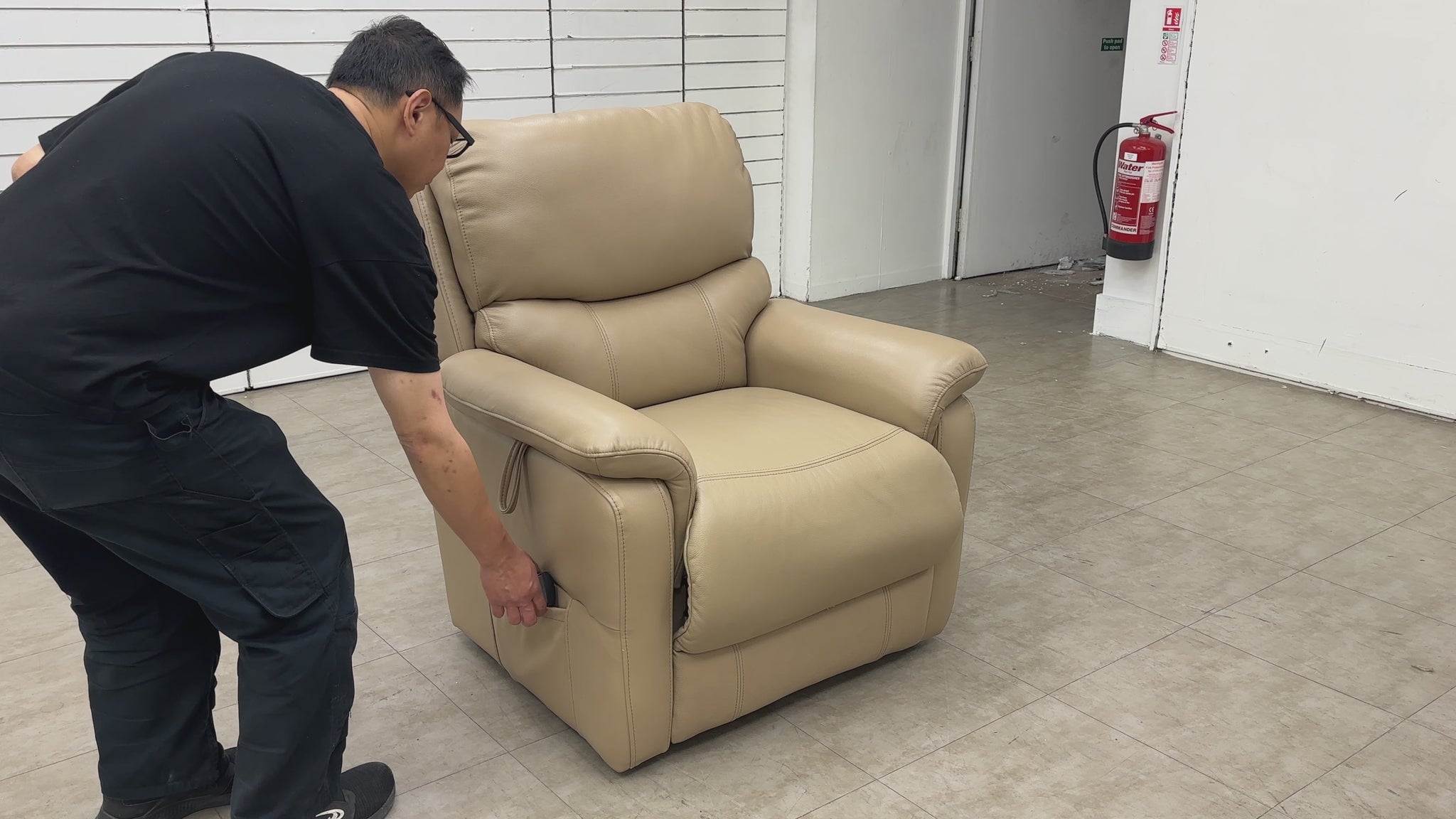 The 'Evelyn' chair in the fully raised and tilted "lift and rise" position, assisting the user in standing up safely.