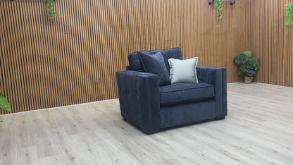 Product video showing the Chelsea love chair from various angles, emphasizing the fabric texture and build quality.