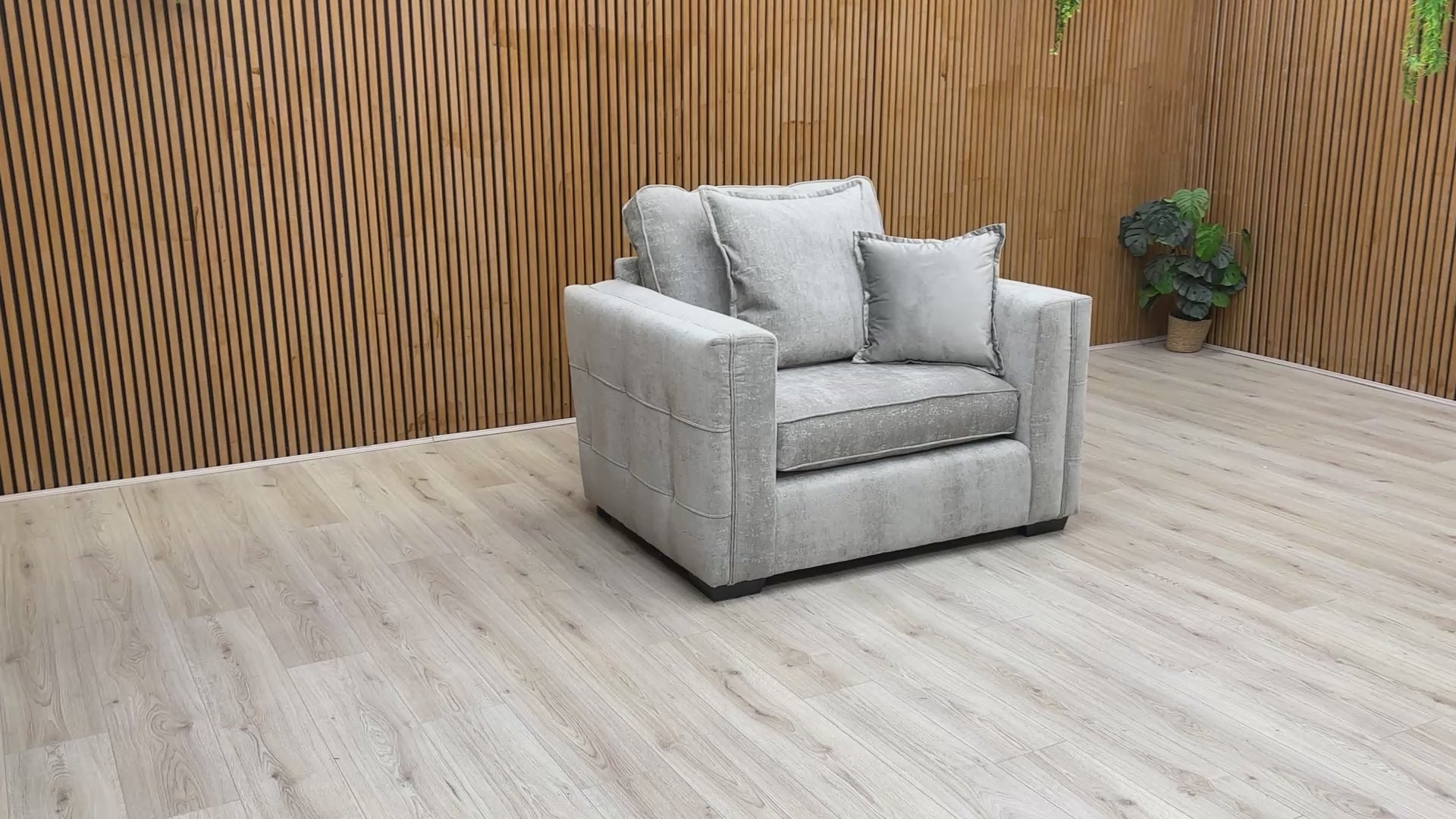 Product tour of the Chelsea cuddler chair, featuring the textured soft weave fabric and demonstrating the comfort of the foam-filled cushions.