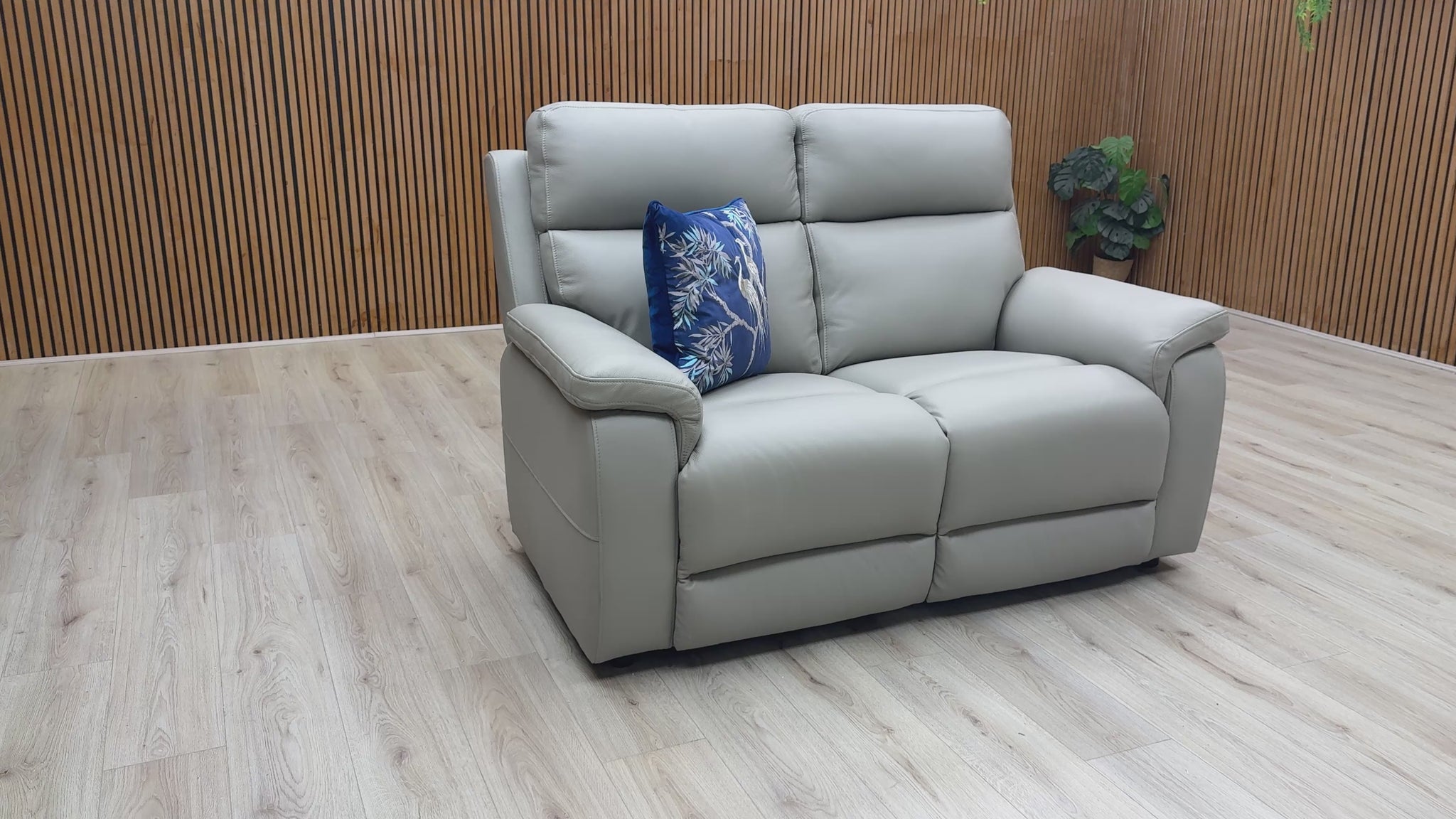 Product walkthrough of the Raven 2-seater sofa, demonstrating leather texture and seat comfort.