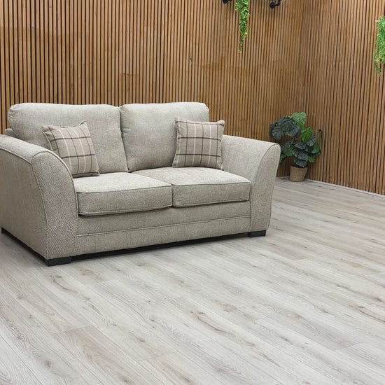 Video play button overlaying the Sophie Sultan sofa bed, demonstrating the transformation from sofa to bed.