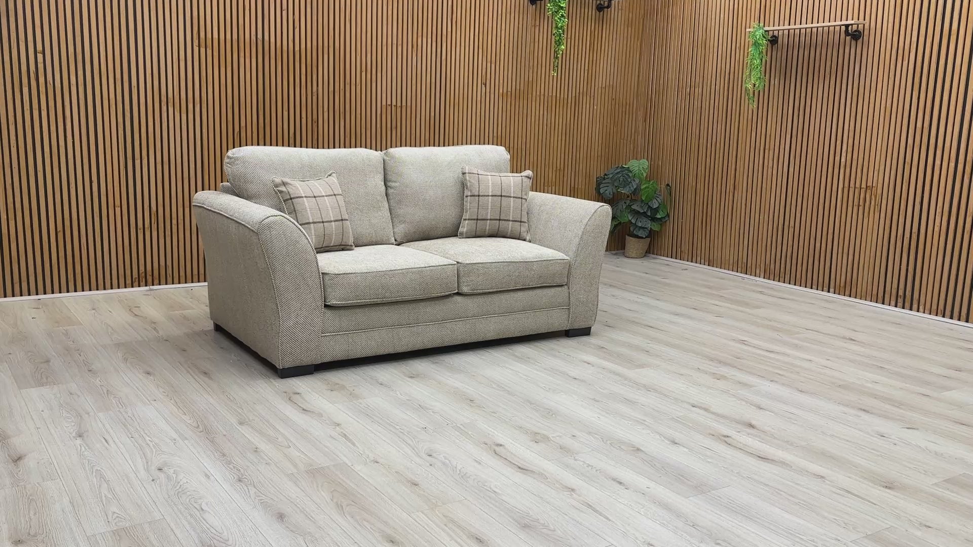 Video play button overlaying the Sophie Sultan sofa bed, demonstrating the transformation from sofa to bed.