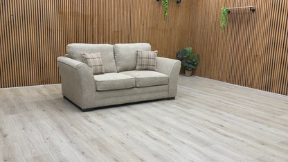Video play button overlaying the Sophie Sultan sofa bed, demonstrating the transformation from sofa to bed.