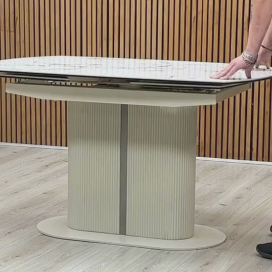 Video demonstration showing the unique swivel action transformation of the Avorio white ceramic dining table. Short clip highlights how a smooth 180-degree twist opens the hidden extension panels automatically.