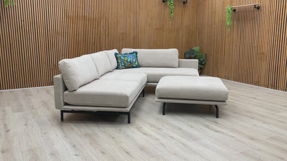 Product walk-around of the Brixton Taupe Fabric Corner Chaise, demonstrating the fabric texture, seat firmness, and footstool versatility.