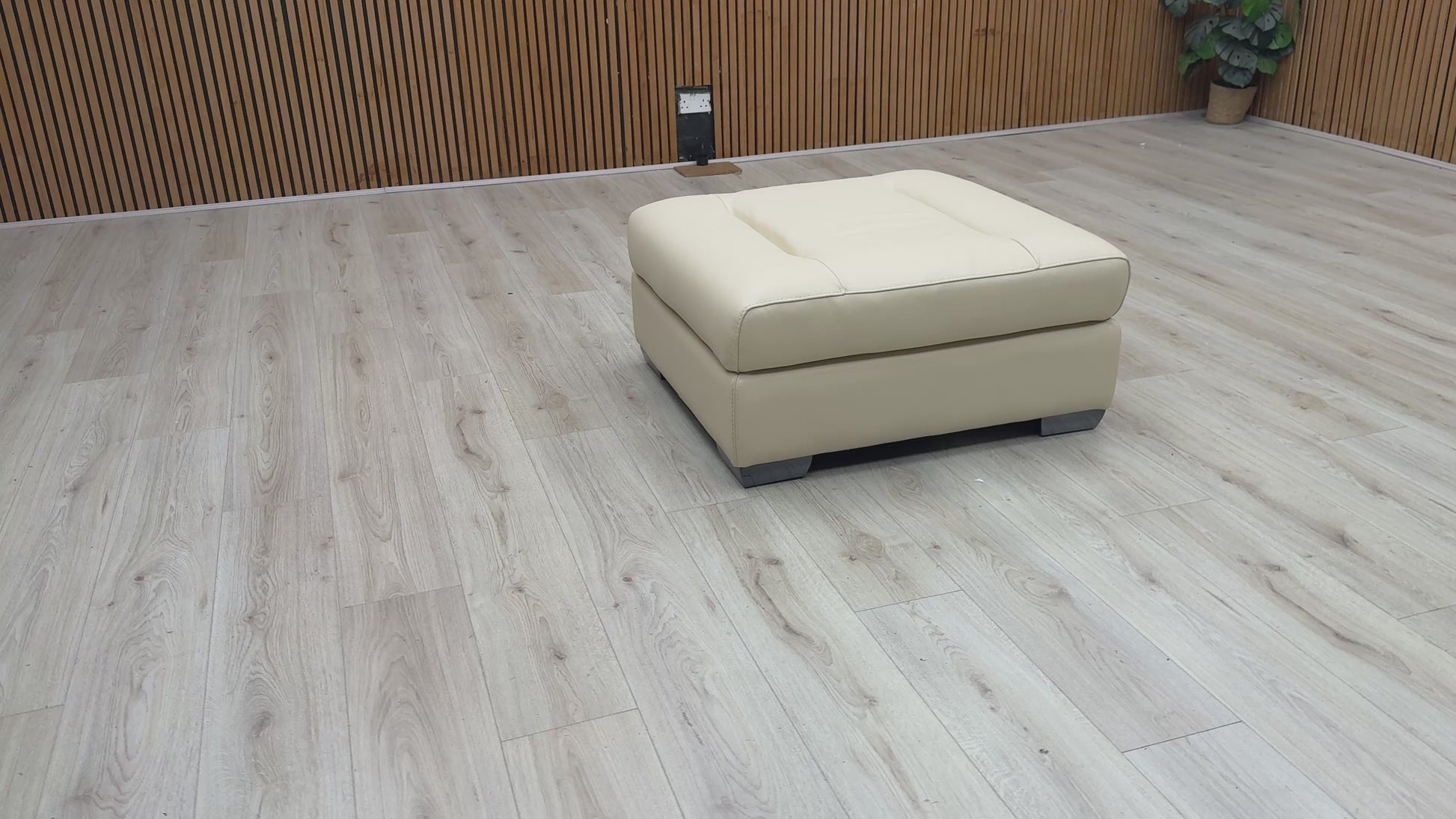 Video Of ‘Action’ contemporary large square footstool, beautifully upholstered in a sophisticated Taupe leather with a clean, modern aesthetic.