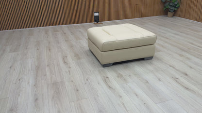 Video Of ‘Action’ contemporary large square footstool, beautifully upholstered in a sophisticated Taupe leather with a clean, modern aesthetic.