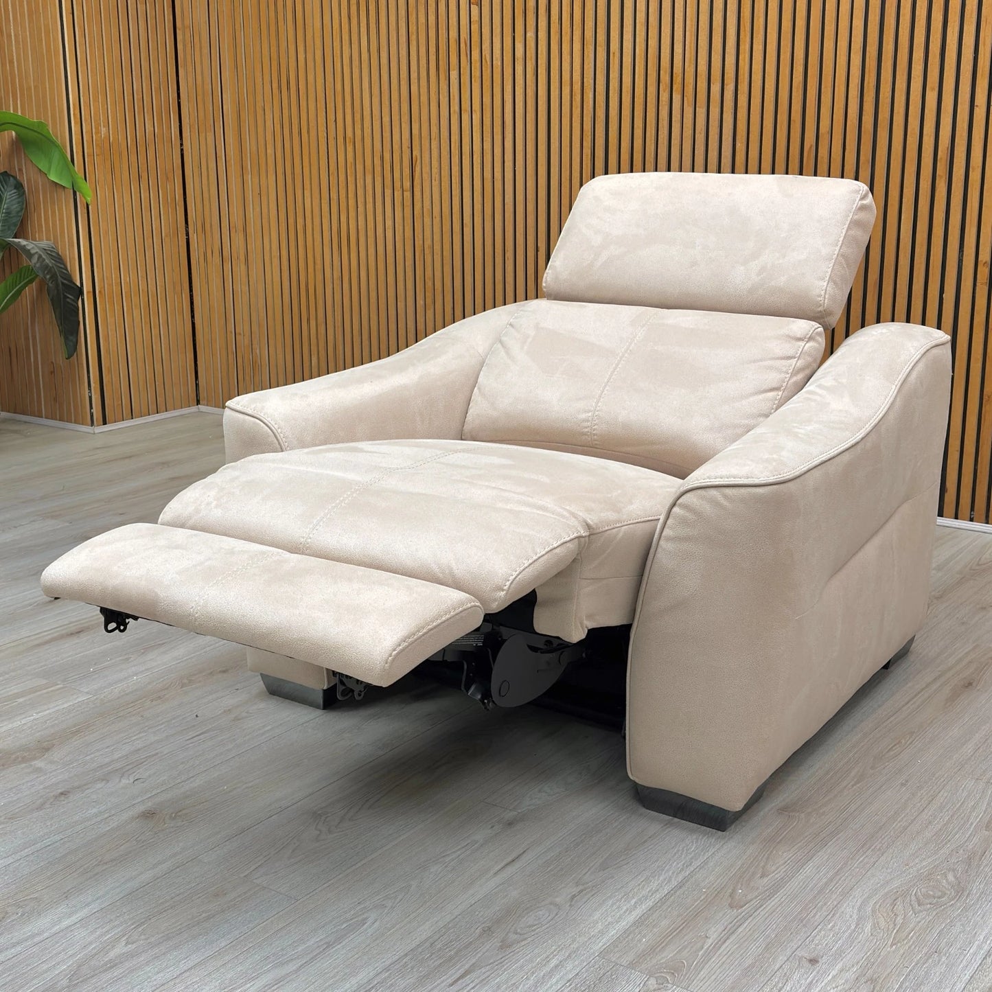 Lifestyle shot of the ‘Xavier’ bisque cream power recliner in a cozy living room setting, highlighting its elegant aesthetic and adjustable headrests.