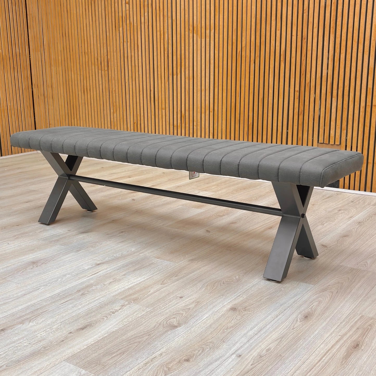 Lifestyle view of the black metal X-shaped legs and frame construction of the 180cm bench.