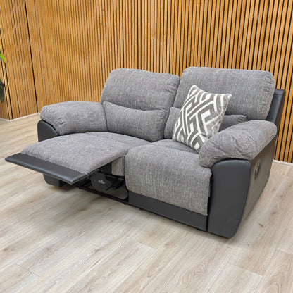 Lifestyle shot of the 'Santori' charcoal sofa, highlighting the comfortable pad arm style.