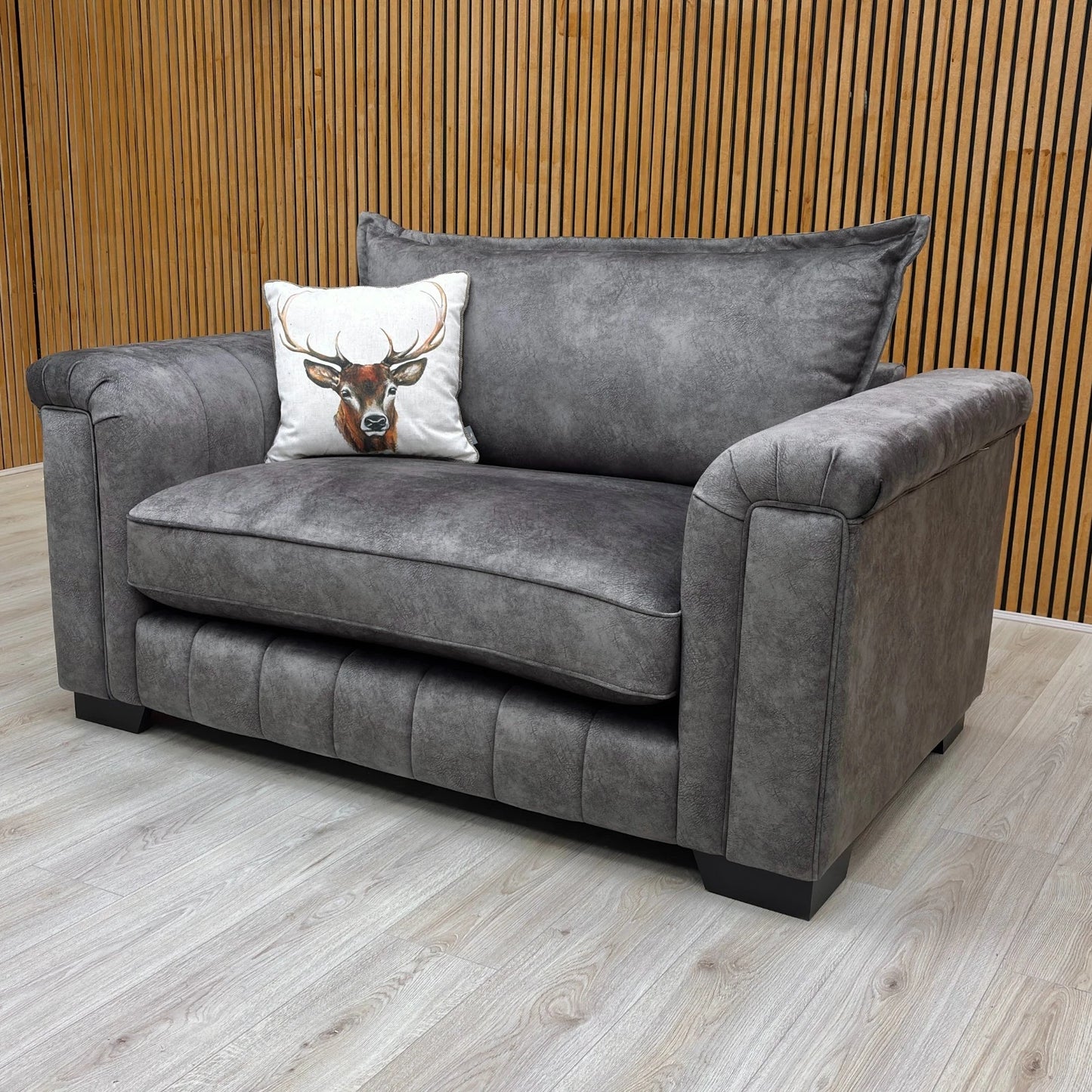 Side view of the cuddler, showing the depth and the high backrest.