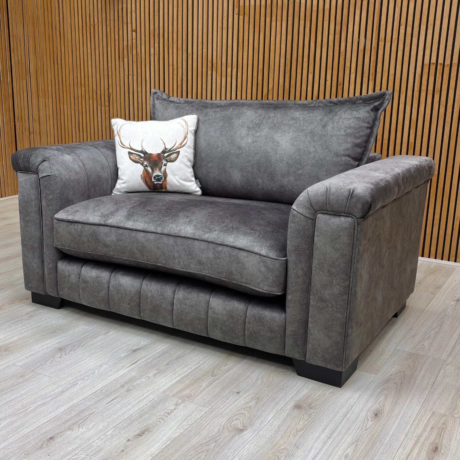 Side view of the cuddler, showing the depth and the high backrest.