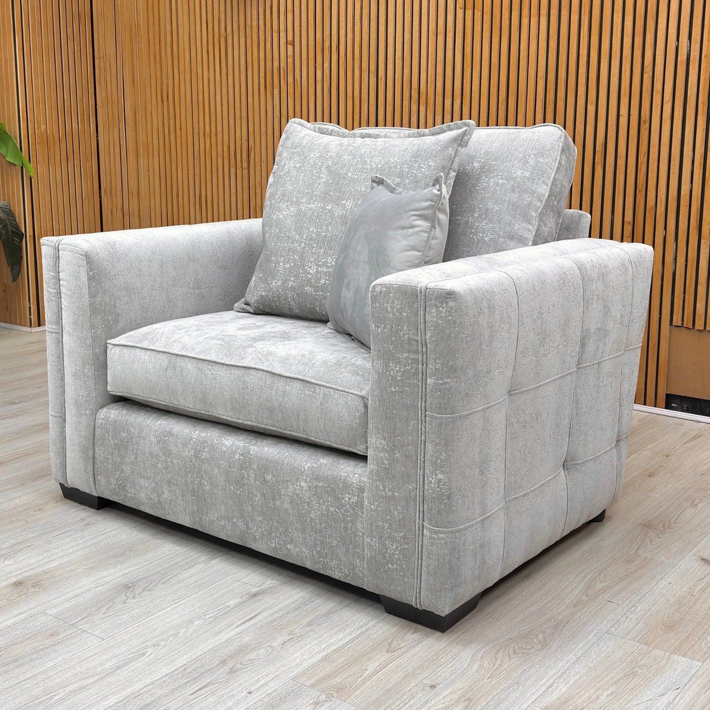 Detailed shot of the contemporary back design and plush cushions on the Chelsea cuddler chair.
