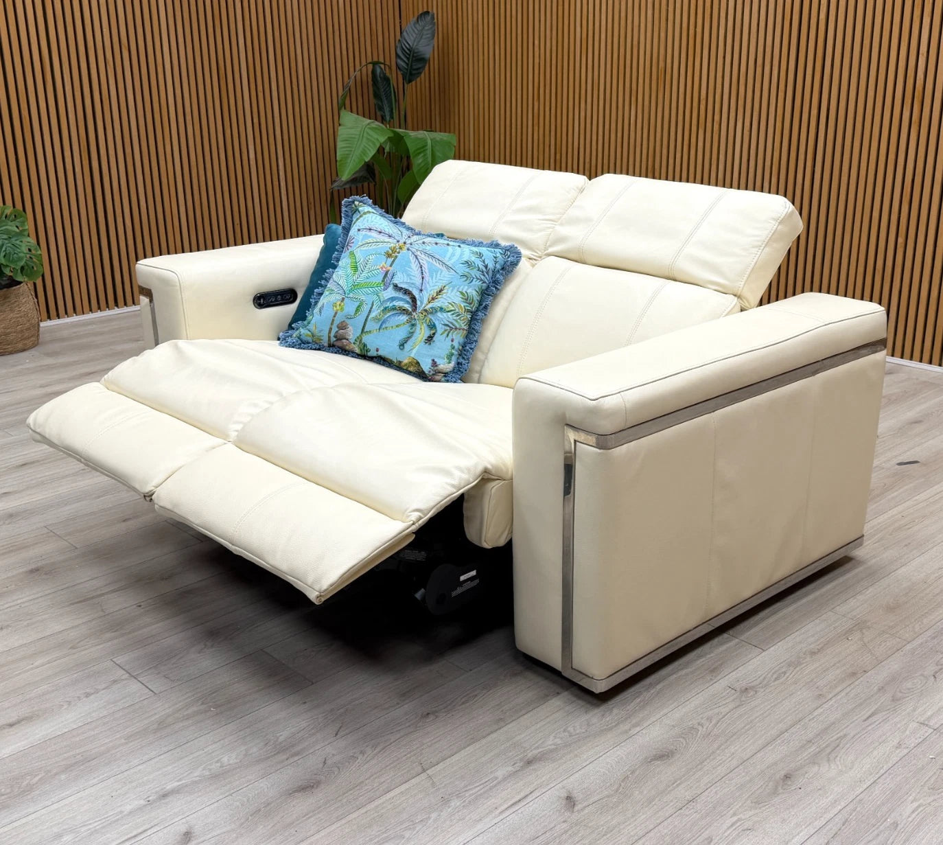 Side profile of the 'Cora' sofa in a reclined position, illustrating the ergonomic support and extent of the power reclining feature.