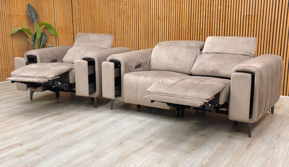 Lifestyle shot of the Cedar Velvet 2-seater sofa and armchair in a modern living room, showcasing the rich green fabric and sleek metal legs.