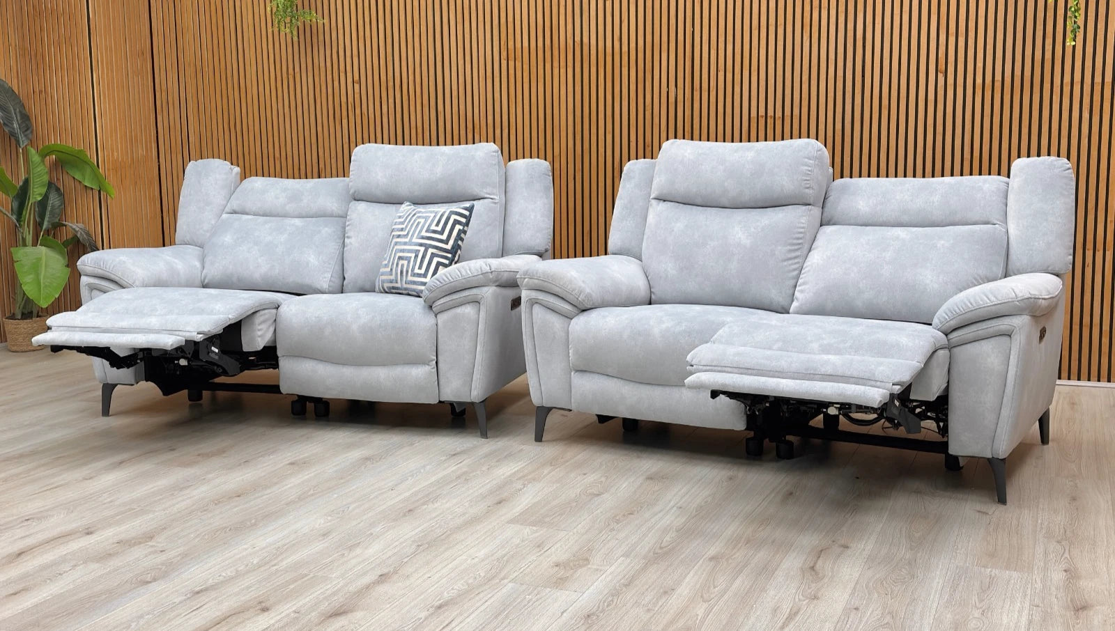 Lifestyle shot of the Panache power recliner sofa set in a modern living room, highlighting the luxurious smoke-toned velvet upholstery and sleek metal legs.