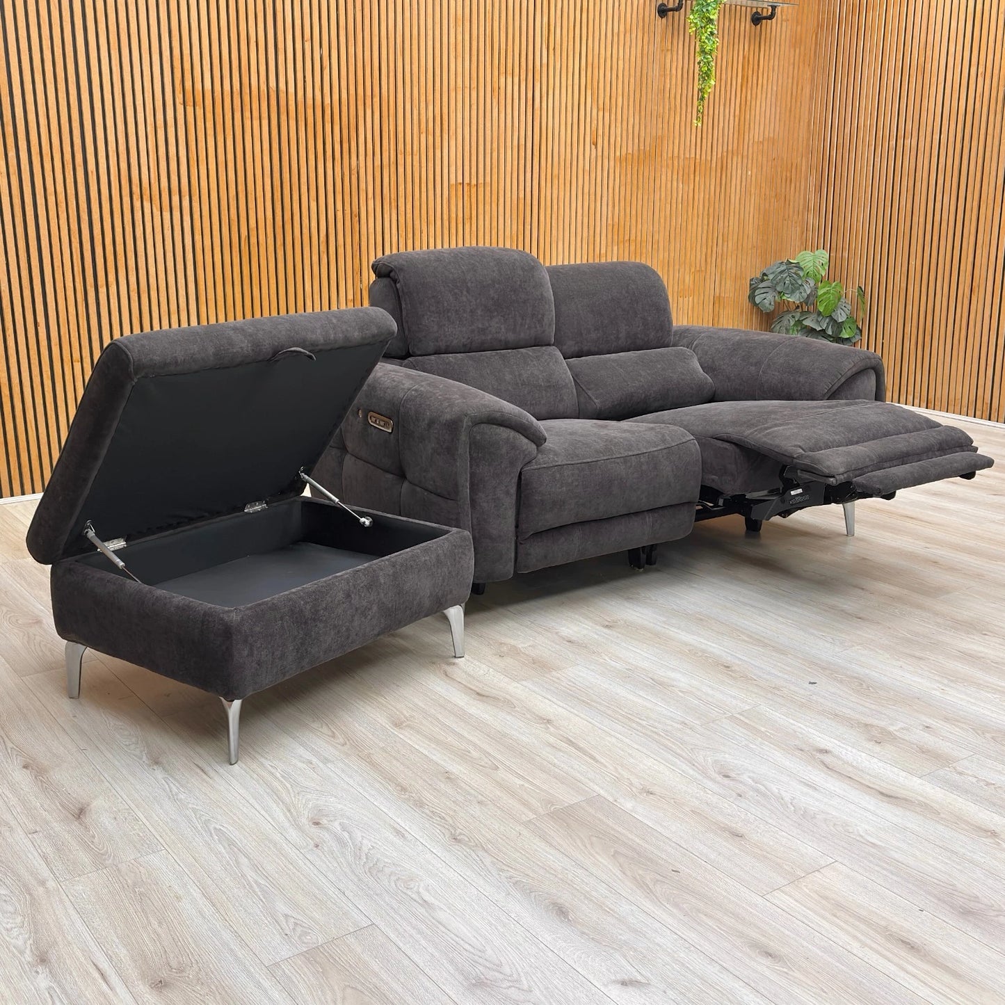 Lifestyle shot of the ‘Vino’ power recliner sofa and footstool set in a modern living room, highlighting the elegant mushroom-toned upholstery.