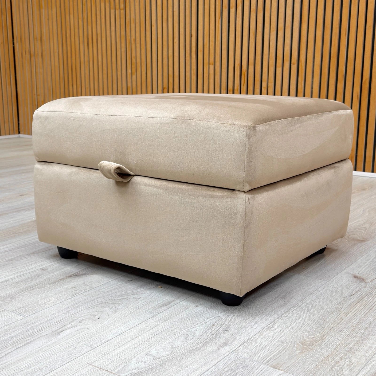 Lifestyle shot of the Mink velvet storage ottoman in a modern living room setting, showcasing its compact size and versatile neutral tone.
