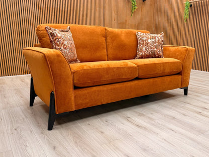 Side view of the 'Collins' sofa, clearly showing the continuous line of the sloped armrest and the generous depth of the seating.