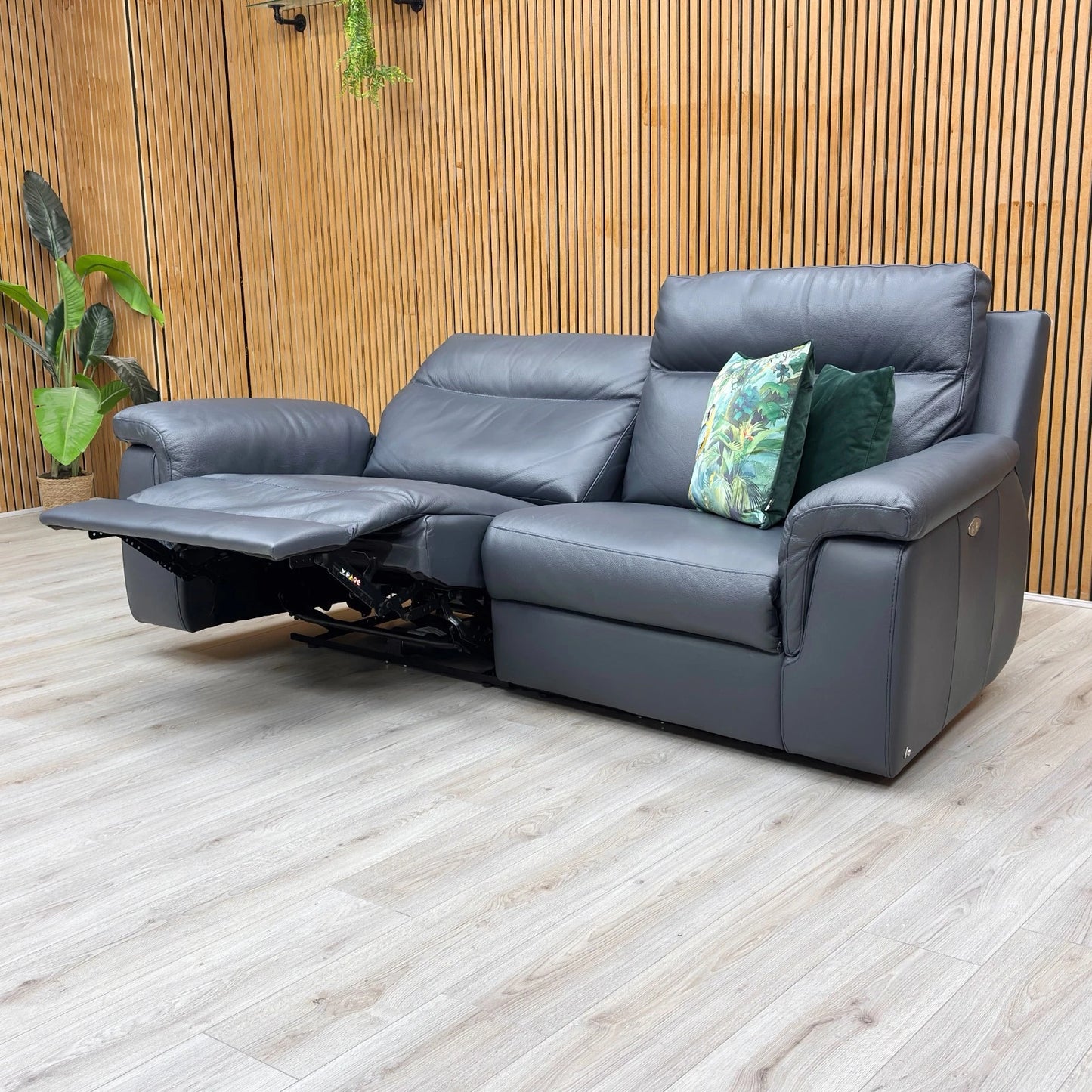 Lifestyle shot of the blue leather sofa in a contemporary living room setting.