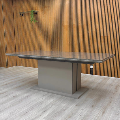 Lifestyle shot of the 'Lusso' Extending Dining Table with chairs, highlighting its size and modern glam style in a dining room setting.