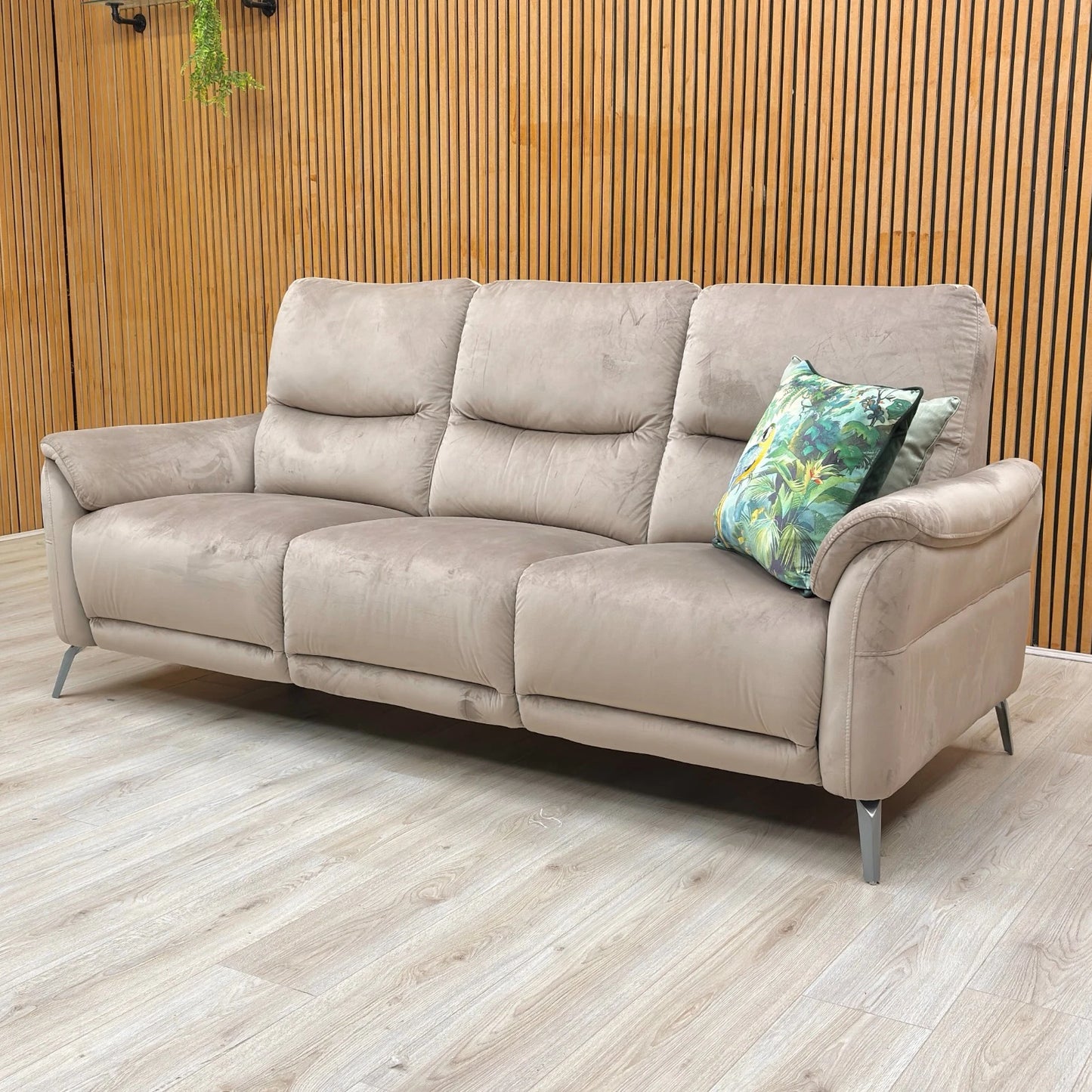 Lifestyle shot of the Cedar velvet Daytona 3-seater sofa in a cozy living room setting, showcasing its elegant and inviting silhouette.