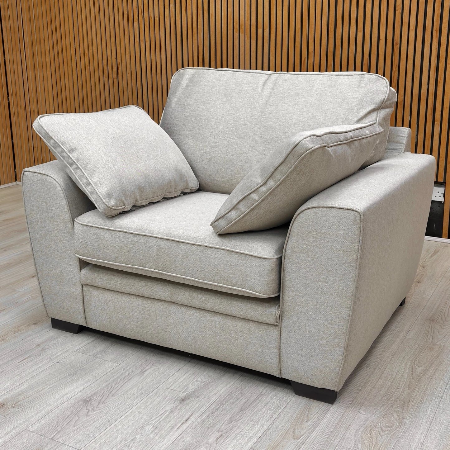 Detailed close-up of the Novak Biscuit soft tight weave fabric, illustrating the texture and color of the upholstery.